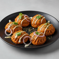 Six Tandoori Malai Momos with creamy malai seasoning, coriander and onion